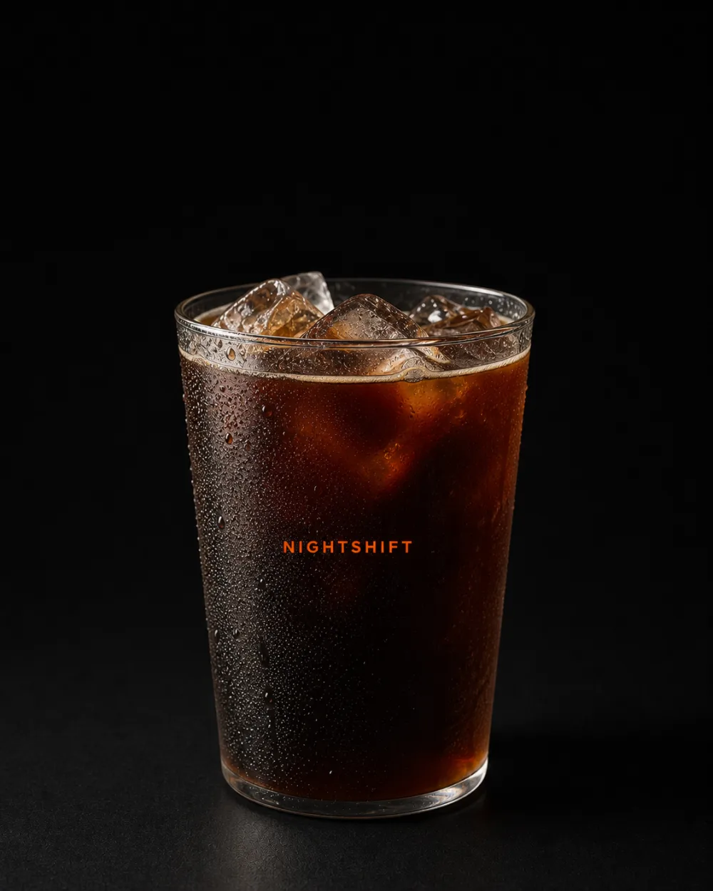 Dark iced Night Americano in a clear Nightshift cup
